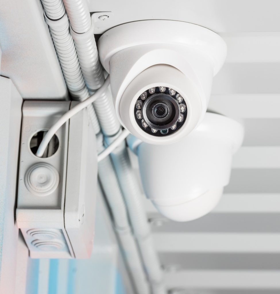 white security camera on ceiling, home security system concept